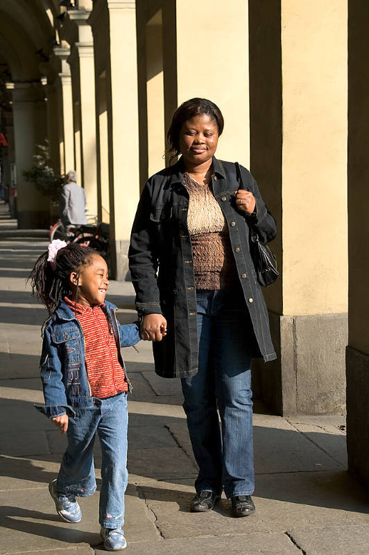 Borderless Captivity, Nigerian woman and daughter shopping, Turin, Italy