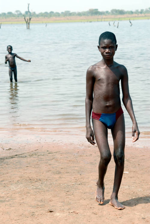 Borderless Captivity, Ghanaian boy, sold by parents, on shores of Lake Volta...