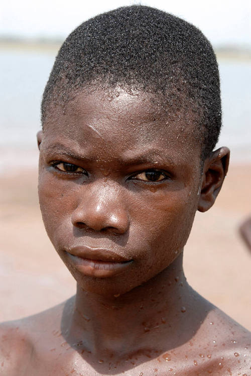 Borderless Captivity, Portrait of enslaved boy, sold by parents to work...