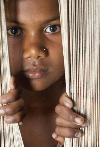 Borderless Captivity, Child carpet weaver, village near Varanarsi, India