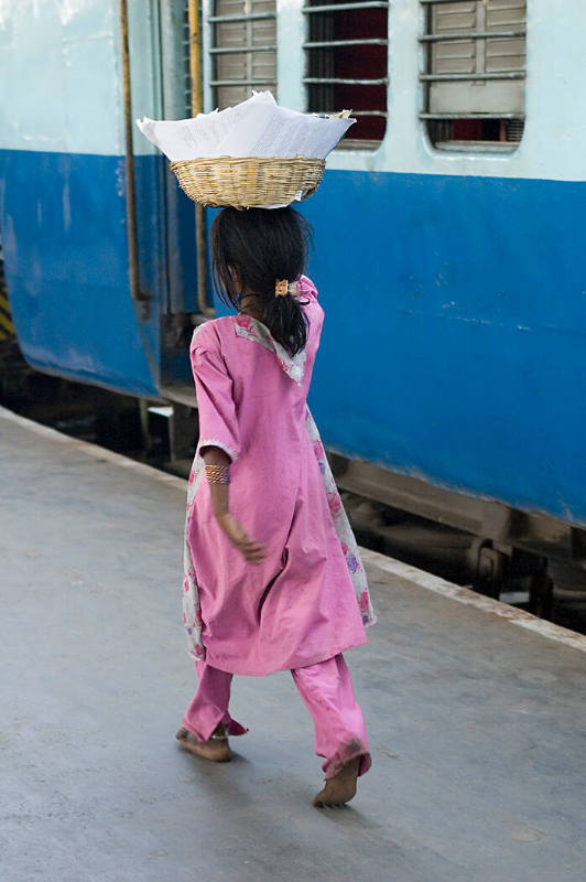 Borderless Captivity, Runaway girl on station platform sells sweets...