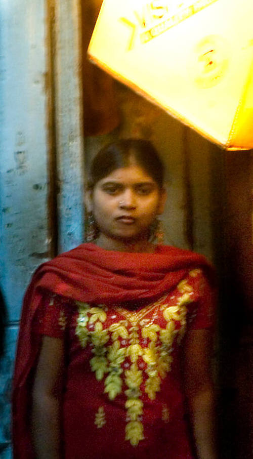 Borderless Captivity, Young woman awaits customer in red light district, Mumbai,