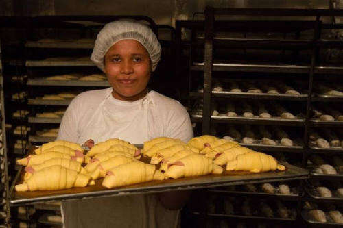 Young woman with sheet of baked goods. Economic Empowerment Program with Casa Alianza. Managua, Nicaragua